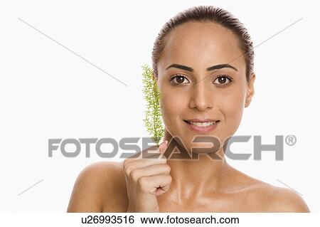 Stock Photograph - Portrait of a woman holding herb. Fotosearch