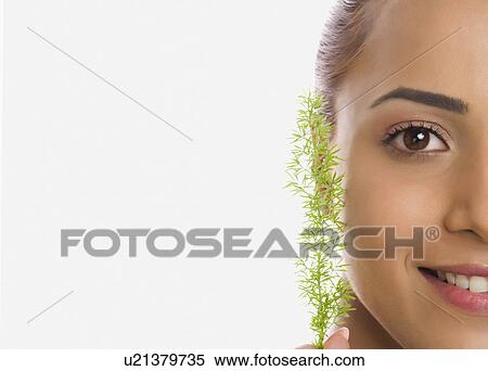 Stock Photography - Portrait of a woman holding herb. Fotosearch