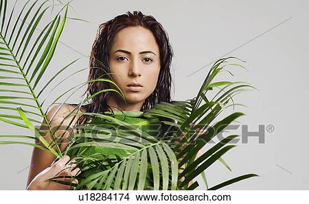 Portrait of a woman holding leaves View Large Photo Image Picture - Portrait of a woman holding leaves. Fotosearch