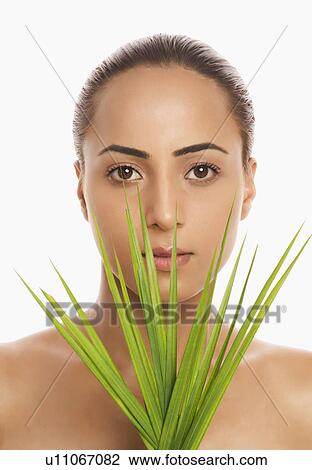 Portrait of a woman holding palm leaves View Large Photo Image Stock Image - Portrait of a woman holding palm leaves. Fotosearch
