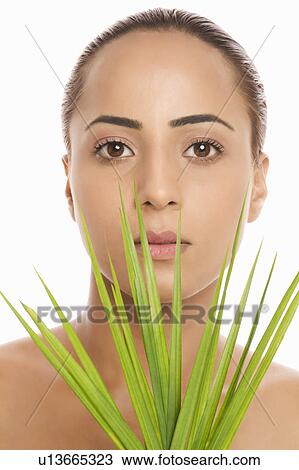Portrait of a woman holding palm leaves View Large Photo Image Stock Image - Portrait of a woman holding palm leaves. Fotosearch