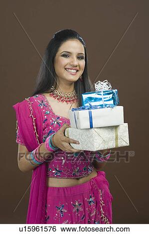 Portrait of a woman holding stack of gifts View Large Photo Image Stock Photograph - Portrait of a woman holding stack of gifts. Fotosearch