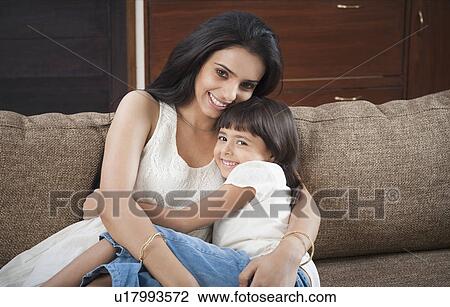 Portrait of a woman hugging her daughter View Large Photo Image Stock Image - Portrait of a woman hugging her daughter. Fotosearch