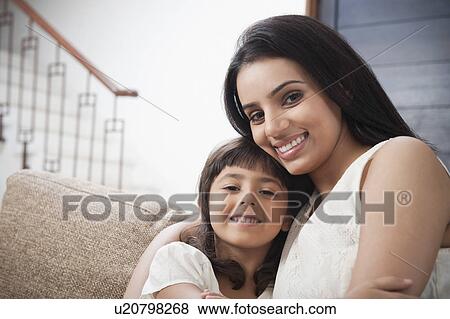 Portrait of a woman smiling with her daughter View Large Photo Image Stock Photo - Portrait of a woman smiling with her daughter. Fotosearch