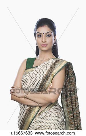 Portrait of a woman standing with her arms crossed View Large Photo Image Stock Image - Portrait of a woman standing with her arms crossed. Fotosearch