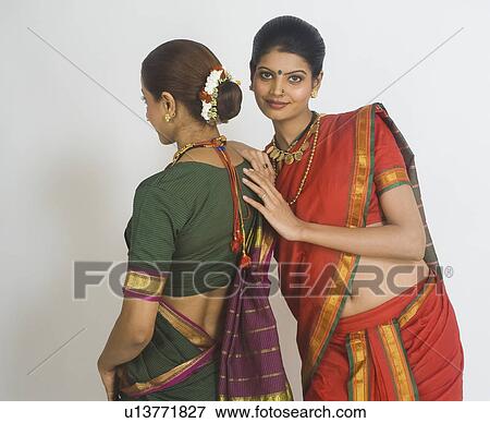 Stock Photo - Portrait of a woman standing with her friend. Fotosearch