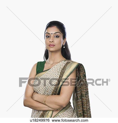 Stock Photograph - Portrait of a woman standing with her arms crossed. Fotosearch