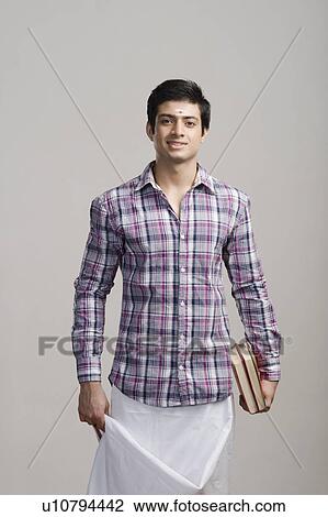 Stock Image - Portrait of an university student holding books. Fotosearch