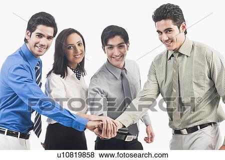 Stock Photo - Portrait of business executives stacking hands. Fotosearch