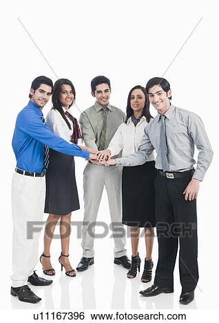 Portrait of business executives stacking hands View Large Photo Image Stock Photograph - Portrait of business executives stacking hands. Fotosearch