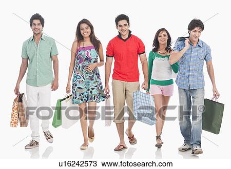 Stock Image - Portrait of friends carrying shopping bags. Fotosearch