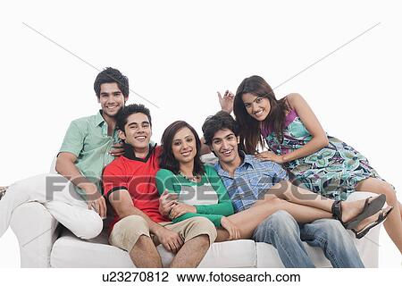 Portrait of friends sitting on couch View Large Photo Image Stock Image - Portrait of friends sitting on couch. Fotosearch