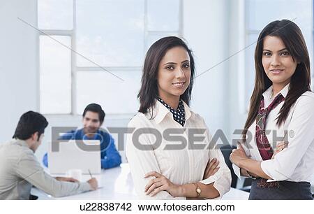 Portrait of two businesswomen with arms crossed View Large Photo Image Stock Image - Portrait of two businesswomen with arms crossed. Fotosearch