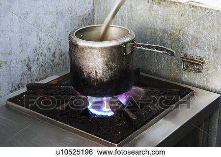 Stock Photograph - Pressure cooker on a stove. Fotosearch