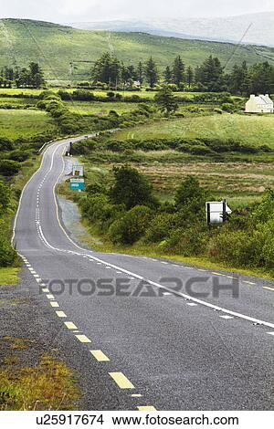 Picture - Road passing through fields, Ring Of Kerry, County Kerry, Republic of Ireland. Fotosearch