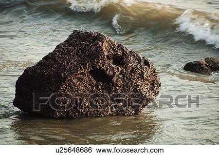 Stock Photograph - Rock on the beach, Goa, India. Fotosearch