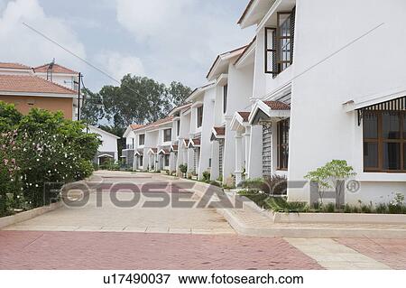 Row of houses on the both sides of a tiled road, Bangalore, Karnataka, India View Large Photo Image Stock Photo - Row of houses on the both sides of a tiled road, Bangalore, Karnataka, India. Fotosearch