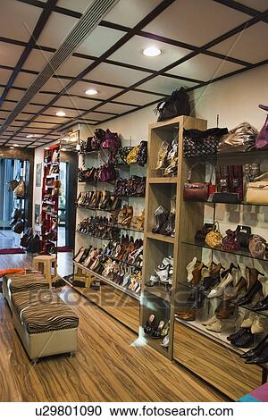 Stock Image - Sandals on display at a shoe store, New Delhi, India. Fotosearch