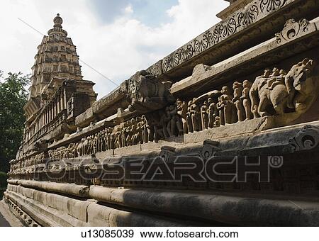 Stock Photo - Sculptures on the wall of a temple, Lakshmana Temple, Khajuraho, Chhatarpur District, Madhya Pradesh, India. Fotosearch