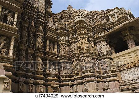 Sculptures on the wall of a temple, Lakshmana Temple, Khajuraho, Chhatarpur District, Madhya Pradesh, India View Large Photo Image Stock Photo - Sculptures on the wall of a temple, Lakshmana Temple, Khajuraho, Chhatarpur District, Madhya Pradesh, India. Fotosearch