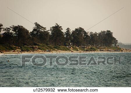Stock Image - Sea with tourists on the beach in the background, Goa, India. Fotosearch