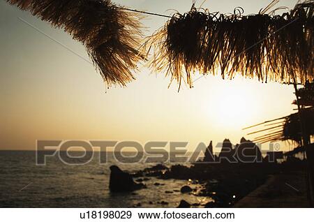 Stock Photo - Silhouette of rocks on the coast, Goa, India. Fotosearch