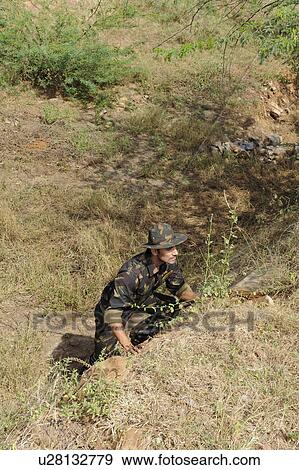 Stock Photo - Soldier in a forest. Fotosearch
