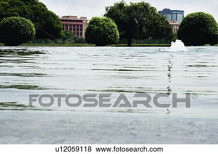 Stock Photo - Splashing water in pond, New Delhi, India. Fotosearch