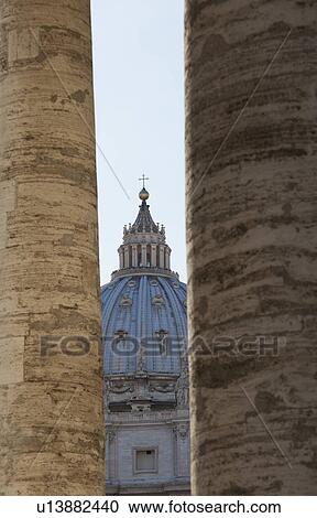 Stock Image - St. Peters Basilica viewed through two columns, Rome, Lazio, Italy. Fotosearch