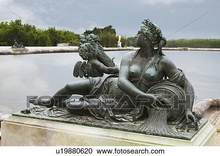 Stock Image - Statue at the poolside, Chateau de Versailles, Versailles, Paris, France. Fotosearch