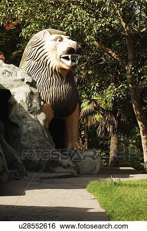 Stock Photograph - Statue of a lion in a garden, Lakshmi Narayan Temple, New Delhi, India. Fotosearch