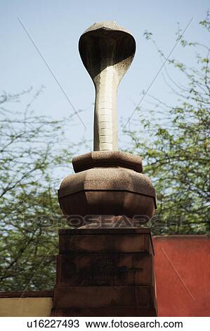 Stock Image - Statue of a snake in a garden, Lakshmi Narayan Temple, New Delhi, India. Fotosearch