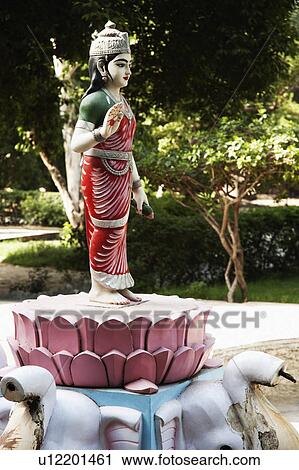 Stock Image - Statue of goddess Lakshmi in the garden of a temple, Lakshmi Narayan Temple, New Delhi, India. Fotosearch
