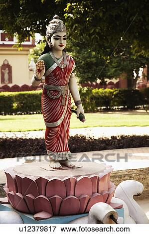 Stock Photo - Statue of goddess Lakshmi in the garden of a temple, Lakshmi Narayan Temple, New Delhi, India. Fotosearch