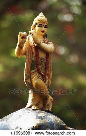 Stock Photo - Statue of lord Krishna in a garden, Lakshmi Narayan Temple, New Delhi, India. Fotosearch