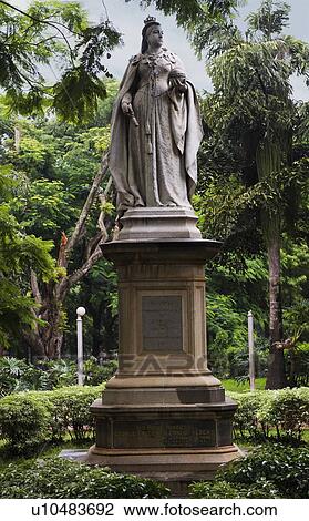 Stock Image - Statue of Queen Victoria in a park, Cubbon Park, Bangalore, Karnataka, India. Fotosearch