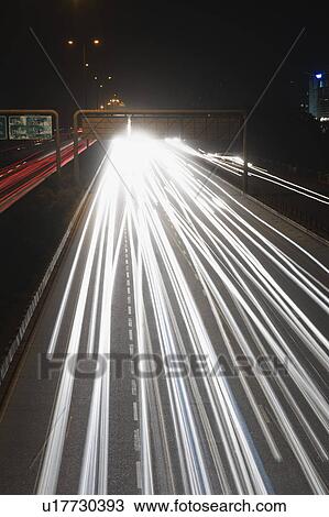 Stock Image - Streaks of headlights of moving vehicles on the road, National Highway 8, Gurgaon, Haryana, India. Fotosearch