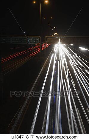 Streaks of headlights of moving vehicles on the road, National Highway 8, Gurgaon, Haryana, India View Large Photo Image Stock Photo - Streaks of headlights of moving vehicles on the road, National Highway 8, Gurgaon, Haryana, India. Fotosearch