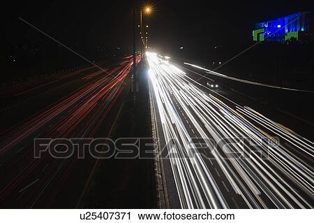 Streaks of lights of moving vehicles on the road, National Highway 8, Gurgaon, Haryana, India View Large Photo Image Stock Image - Streaks of lights of moving vehicles on the road, National Highway 8, Gurgaon, Haryana, India. Fotosearch
