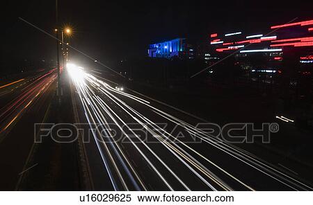Stock Photography - Streaks of lights of moving vehicles on the road, National Highway 8, Gurgaon, Haryana, India. Fotosearch