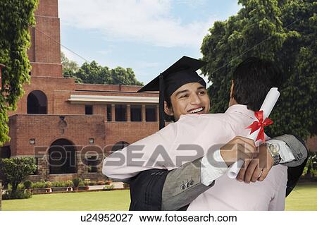 Student hugging his father after getting diploma View Large Photo Image Stock Photo - Student hugging his father after getting diploma. Fotosearch