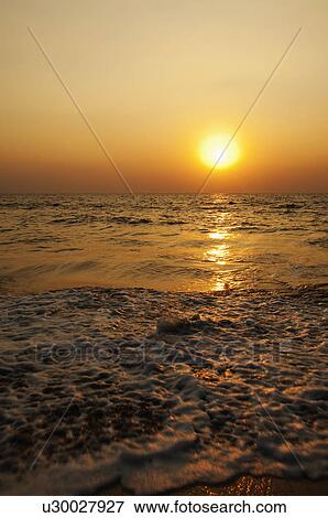 Stock Photo - Sunset over the sea, Goa, India. Fotosearch