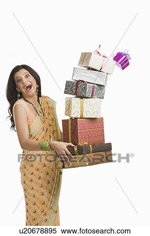 Surprised woman holding gifts at Diwali festival View Large Photo Image Stock Photography - Surprised woman holding gifts at Diwali festival. Fotosearch