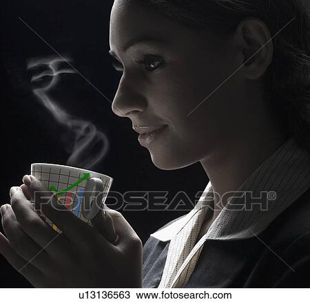 Symbol of Indian currency emerging from a cup of coffee hold by a woman View Large Photo Image Stock Image - Symbol of Indian currency emerging from a cup of coffee hold by a woman. Fotosearch