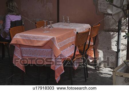 Stock Image - Table and chairs in a restaurant, Rome, Lazio, Italy. Fotosearch