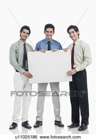 Three businessmen holding a whiteboard View Large Photo Image Stock Photograph - Three businessmen holding a whiteboard. Fotosearch