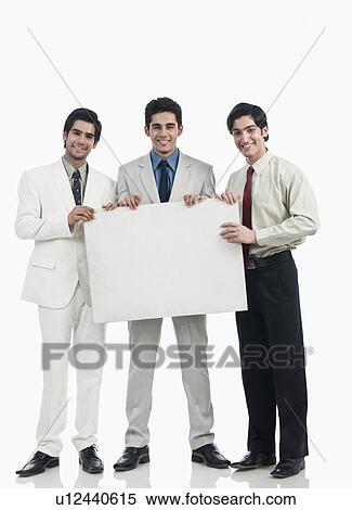 Three businessmen holding a whiteboard View Large Photo Image Stock Photography - Three businessmen holding a whiteboard. Fotosearch