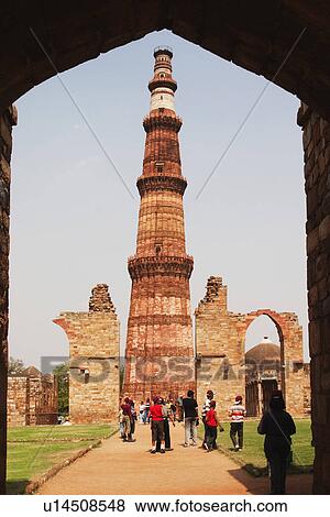 Stock Photo - Tourists at a monument, Qutub Minar, New Delhi, India. Fotosearch