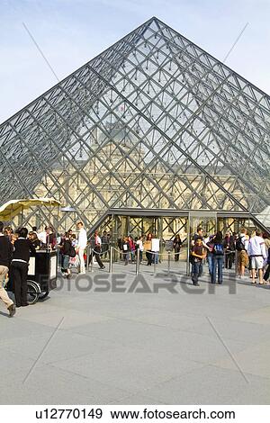 Tourists near a pyramid, Louvre Pyramid, Musee du Louvre, Paris, France View Large Photo Image Stock Photo - Tourists near a pyramid, Louvre Pyramid, Musee du Louvre, Paris, France. Fotosearch