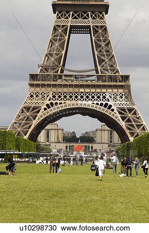 Stock Image - Tourists near a tower, Eiffel Tower, Paris, France. Fotosearch